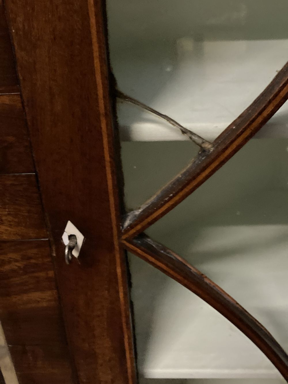 A George III mahogany hanging corner cupboard with glazed door, width 74cm, depth 39cm, height 110cm